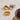 Two gold rings and a silver ring on a textured white surface.
