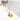 Gold necklace with a heart-shaped pendant on a light gray background