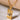 Gold pendant necklace with eye design on a beige surface