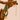 green beaded gold necklace with coin pendant charm on wooden branch