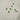 Gold necklace and earrings with green clover-shaped charms on a white surface