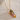 Necklace with floral pendant on a textured white background