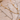 Two gold and silver necklaces on a textured beige surface