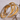 Three gold and silver bracelets stacked on a textured surface