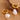 Gold hoop earrings with white pearls on a brown surface