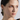 woman wearing gold hoop earrings with flower charm