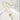 Gold chain necklace with a pearl pendant on a white surface