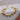 Gold chain bracelet on a textured gray surface