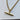 Gold necklace with a cylindrical pendant on a light gray background