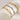 Two gold bracelets, one with a chain link design, on a white cylindrical background.