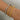 Two bangles, one in gold color and the other in silver color, displayed on a person's wrist.
