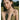 Woman in a field touching her face with a blurred natural background