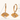 Gold hoop earrings with face designs and gemstones, shown with measurements on a white background.