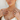 Woman wearing gold jewelry including necklaces, rings, and earrings on a neutral background