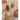 Three gold-rimmed gemstone rings on a textured surface