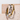 Two gold and silver rings on a textured beige surface