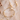 Gold necklace with pearl-like beads on a textured beige surface