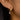 Gold and silver teardrop earring worn on an ear