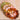 Colorful beaded bracelet on a textured surface with an apple in the background