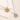 Two necklaces with circular pendants on a textured surface