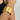Gold textured cuff bracelet on a wrist against a neutral background