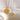 Two necklaces with circular pendants featuring sun designs on a light background