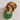Gold and green hoop earrings on a light surface