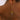 Gold heart-shaped earrings on a person's ear with a blurred background