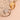 Two gold rings with diamond accents on a textured beige surface