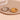 Two gold and silver rings with star designs on a beige surface