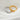 Two rings, one gold and one silver, on a white fabric background