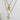 Gold necklace with two pendants on a white background
