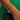 Close-up of a wrist wearing gold bracelets with a green fabric background