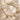 Gold bracelet with various charms on a beige surface