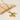 Gold necklace with a green pendant on a beige stone surface