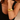 Gold bracelet on a person's wrist with a neutral background