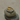 Gold and silver ring on a stack of stones with a neutral background