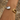 Gold ring on a wrist with a textured background