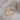 Gold and silver open bangle on a textured surface