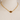 Gold chain necklace with a brown gemstone on a mannequin bust.