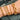 Gold bracelets on a wrist with a blurred background