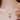 Gold necklace with a pendant on a person's neck