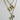 Gold necklace with two pendant charms on a light gray background
