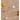 Jewelry set with gold and silver necklaces on a textured surface with fruits.