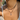 Necklace with a pendant on a person's neck against a blurred background