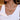 Gold necklace with a blue gemstone pendant on a person wearing a white top.