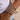 Close-up of a wrist wearing multiple diamond-studded bracelets with a blurred background.